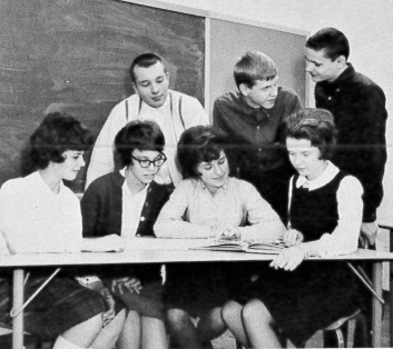 male and female students looking over a book