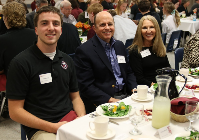 Concordia Cadet with parents at a dinner