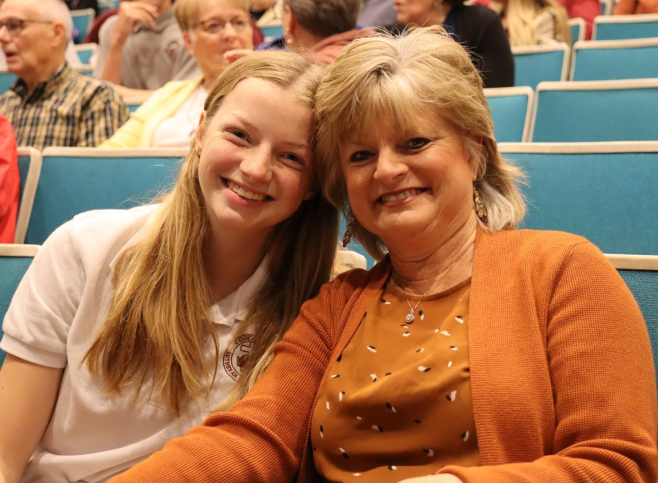 two women smiling at the camera for a photo